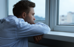 A photo of a young person looking sad