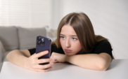 A photo of a teenager using a phone