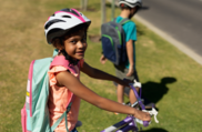 A photo of a child wearing a helmet and smiling