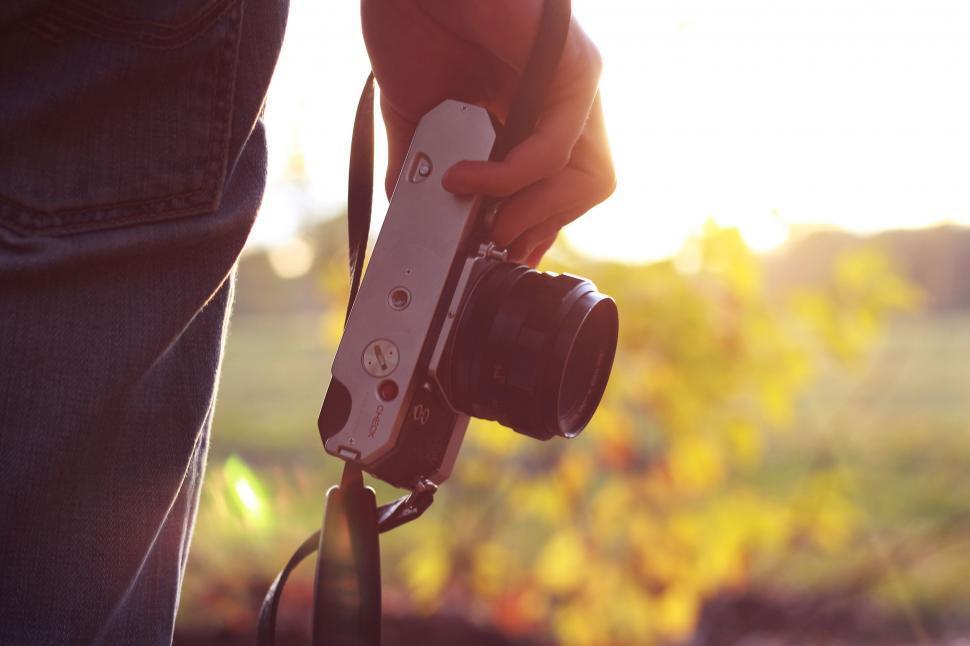 Person holding camera in countryside