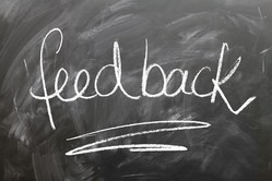 the word 'feedback' is written on a chalk board