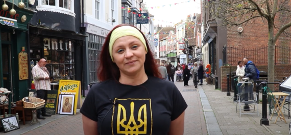 Woman in street wearing T-shirt with Ukraine trident symbol