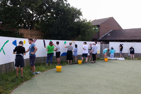 A group of young people, volunteers and ISEND team members working on the SEND Art Mural Project Summer 2022 in Eastbourne.