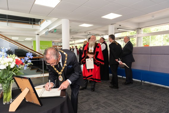 Man bends to sign book of condolence at County Hall reception