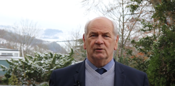 In front of snow-covered downs, council leader Keith Glazier