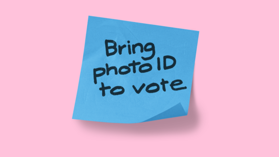 post-it note which reads "Bring Photo ID to vote"