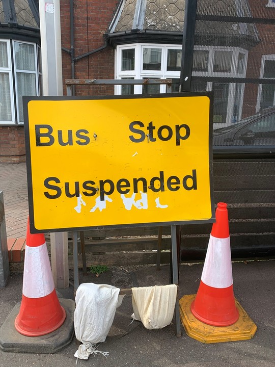 Road sign showing bus stop suspension.