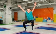 Boy jumping on trampoline