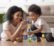 Mother and son playing with bricks