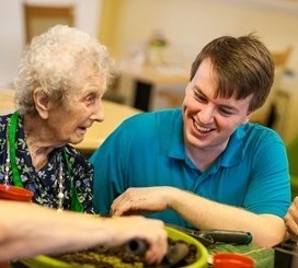 Male carer with older woman