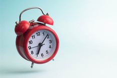 Red arlam clock on a blue background