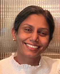 Photo of Dr Easwari Kothandaraman smiling in a white dress.