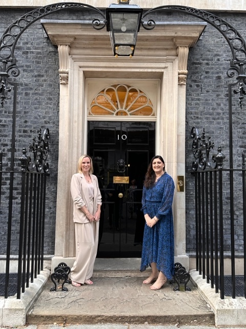 Two people stood outside No 10 Downing Street