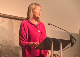 Woman speaking at a lectern