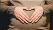 Image: Pregnant woman holding her hands in a heart shape