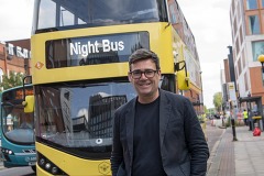 Andy Burnham pictured with a yellow Night Bus