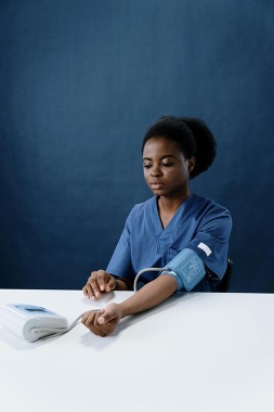 Woman taking her blood pressure reading