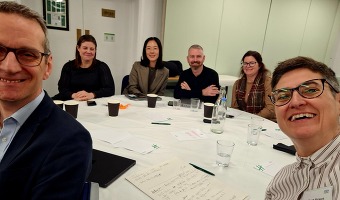 Group of people in a room from thrombectomy meeting 