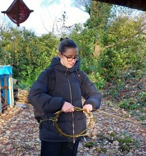 Aiste taking part in wreath making activity