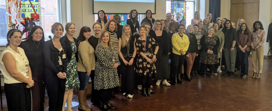 Large group photo of attendees at both events