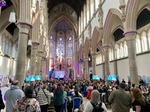 400 attendees at the Manchester Monastery, seated listening to the opening session