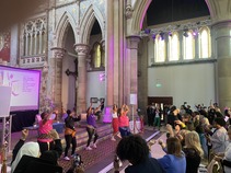 Group of dancers on stage leading attendees in dance moves