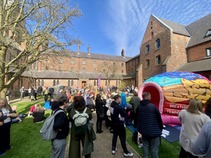 People standing in the Monastery courtyard during the break