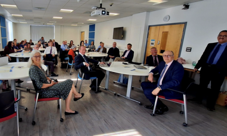 Photo of people in meeting discussing thrombectomy update