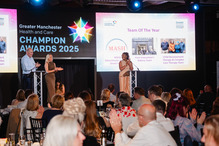 people clapping nominees on the stage with awards logo behind