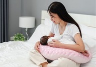 lady holding baby on a pillow