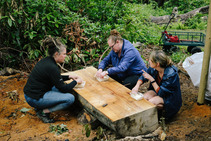 People talking around a table in the woods