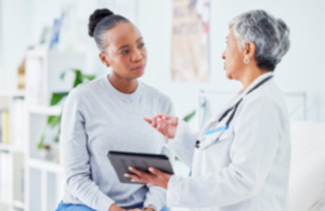 a doctor comforting a pregnant female
