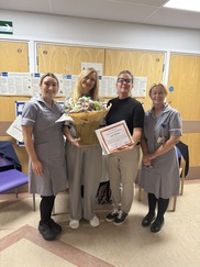 Four females stood with jayne in the middle holding flowers