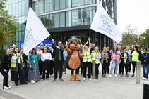 A group of people at the launch of the Beat the Streets Salford game, standing outside and cheering