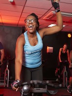 black female on a spinning bike cheering