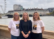 three females stood in front of the river thames