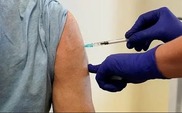 close up of upper arm getting an injection