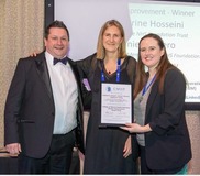 three people holding the star award