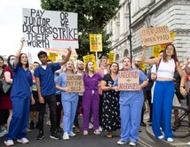 doctors outside protesting holding plaques