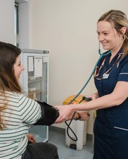 Nurse taking blood pressure
