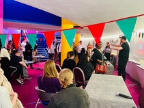 Workshop with lots of people talking and bunting in the foreground