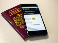 Smartphone showing HM Land Registry website, laid over passport.