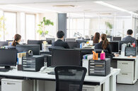 Colleagues working at desks in an open-plan office