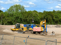 Construction machines on land which has been cleared for a new housing development