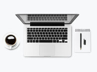 Laptop with coffee cup on one side and notebook and pen on the other