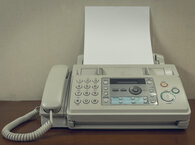 A fax machine on a table.