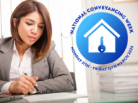 A woman sitting at a desk, holding a pen over a sheet of paper and with a laptop open; a superimposed logo says 'National Conveyancing Week'.