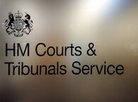 Polished wall panel saying 'HM Courts & Tribunals Service'