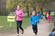 A mother and child run through a park while participating in a parkrun. A new junior parkrun is being launched.