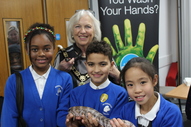 Mayor of Hertsmere Councillor Brenda Batten with children from Monksmead Primary School and a reptile